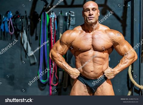 Confident Bodybuilder Arms Akimbo Flexing Muscles Stock Photo ...