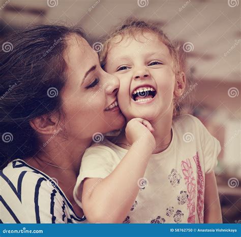 Mom Kissing Daughter