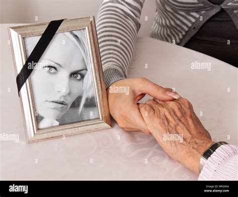 Holding hands for comfort. Grief at death Stock Photo - Alamy