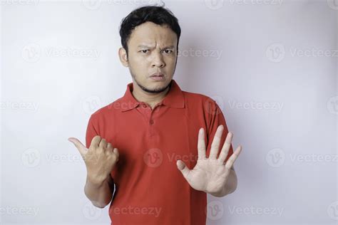 Attractive Asian man with hand gesture pose rejection or prohibition ...