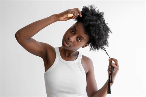 photo young woman styling hair front view