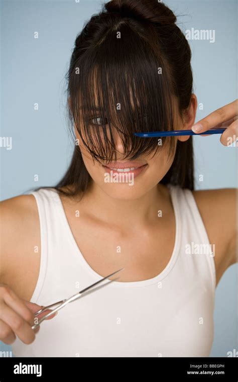 Woman Cutting Her Bangs Stock Photo - Alamy