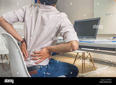 Tired exhausted man feeling pain in his back Stock Photo - Alamy