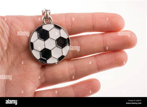 Football shaped keyholder in hand on a white background Stock Photo - Alamy