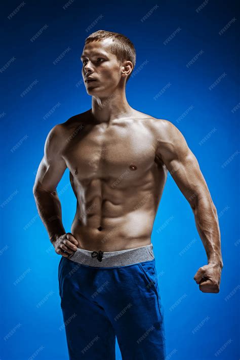 Free Photo | Fit young man with beautiful torso on blue
