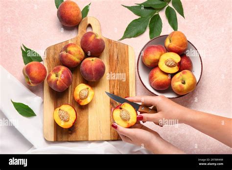 woman cutting sweet peach  pink background stock photo alamy