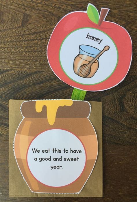 an apple and honey themed bookmark with the words we eat this to have a ...
