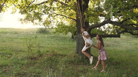 children swinging  swing   oak branch  sun dreams  flying