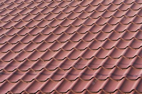 Premium Photo | Red metal roof tiles the texture of shingles