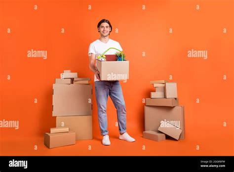 full body photo  happy positive cheerful man hold hands move boxes