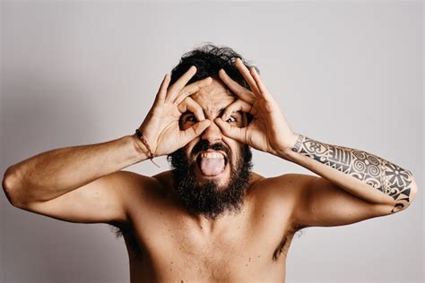 Premium Photo | Young guy with a beard making funny gestures