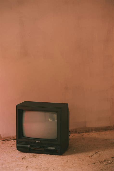Old TV set on rough floor in house · Free Stock Photo