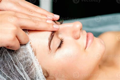 Female therapist making forehead massage 22429566 Stock Photo at Vecteezy