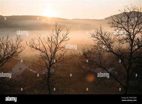 Foggy sunrise landscape in autumn mountains village Stock Photo - Alamy