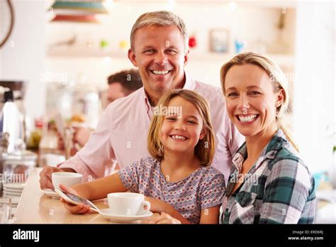 Happy family in a cafe Stock Photo - Alamy