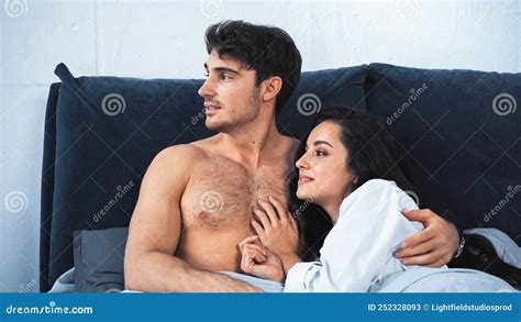 shirtless boyfriend  smiling girlfriend  stock image image