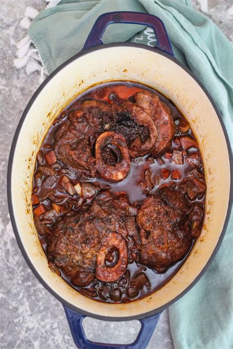 An oval, enameled Dutch Oven showing braised beef shanks in it!! Dutch ...