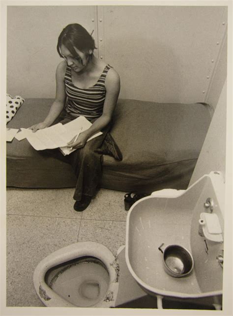 [Woman wearing street clothes sitting on a bunk in a Travis County Jail ...