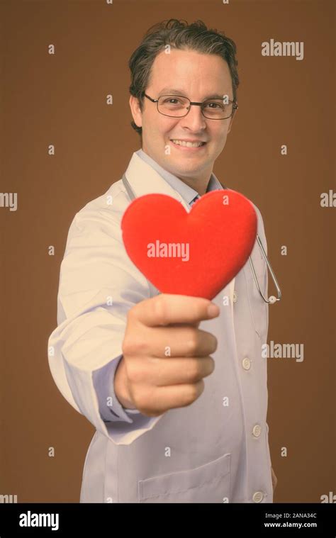 studio shot  italian man doctor  brown background stock photo