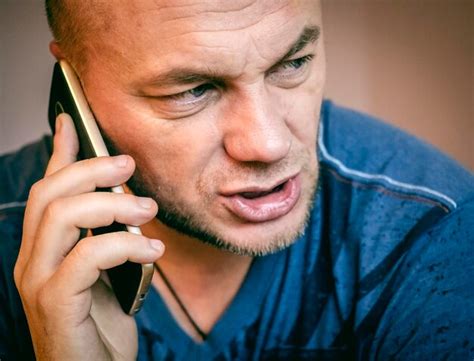 premium photo close   mature man talking  mobile phone