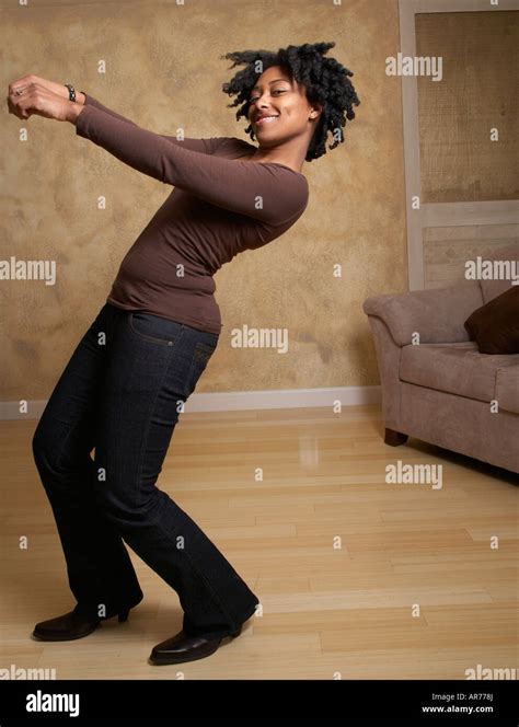 African woman dancing in livingroom Stock Photo - Alamy