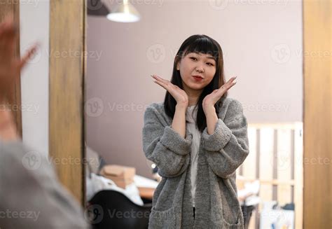 Cute Asian Korean girl chooses clothes, takes care of herself and poses