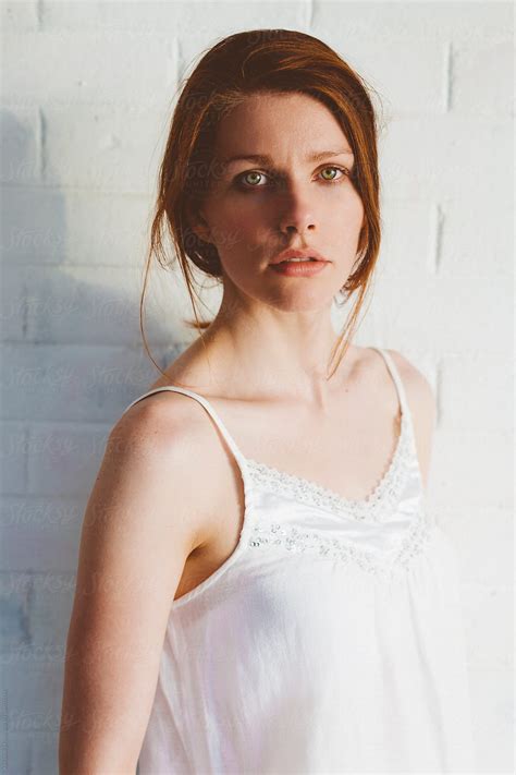 "Portrait Of Red Hair Woman In Front Of White Brick Wall" by Stocksy ...