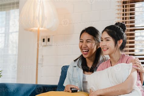 Young Asia Lesbian lgbtq women couple watching TV at home, Asian lover