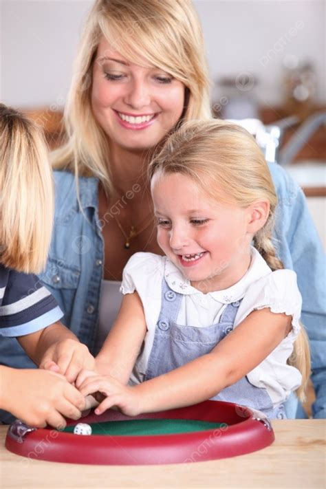 Mother Watching Children Play With Dice Photo Background And Picture