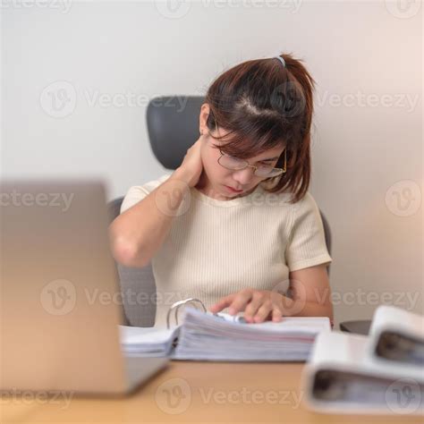 Woman having Neck and Shoulder pain during work long time on workplace