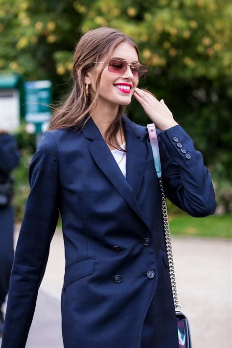 kaia gerber is all smiles as she steps out in a blue pantsuit in paris ...