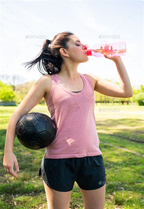 Female soccer player drinking water from bottle. in 2024 | Female ...