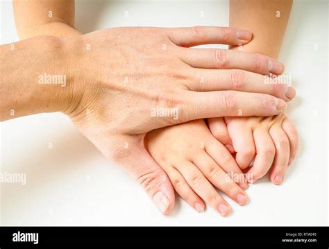 toddlers hands  fathers hands    white table stock
