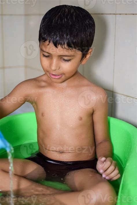 Cute Indian Boy having bath during the summer vacation season, Cute