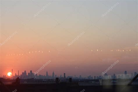 Sunrise appears over Newark and New York City skyline at Newark Liberty ...