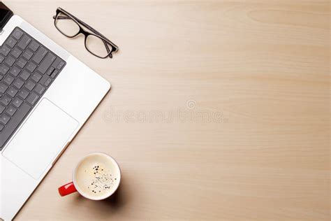 A Clean and Minimal Desk Setup Featuring a Laptop and a Coffee Cup