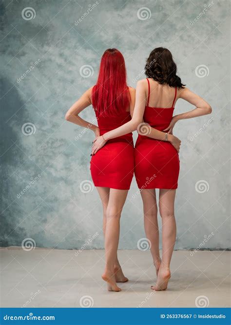 Full-length Portrait of Two Tenderly Embracing Women Dressed in