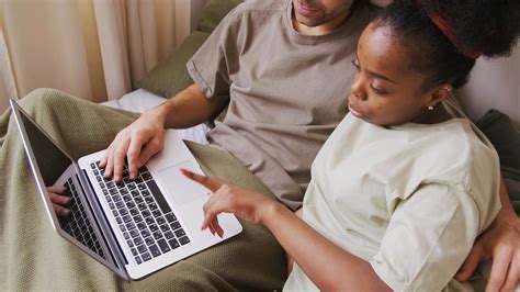 A Couple Discussing Work Using A Laptop While Staying Home · Free Stock