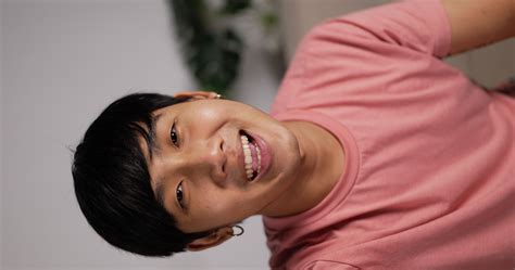 Vertical POV Video Call Portrait of Asian young man talking to friends