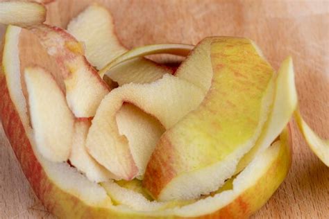 Premium Photo | Peeled red apple the peel of a peeled apple scattered ...