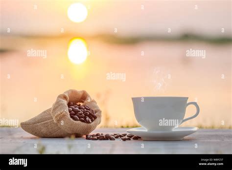 coffee cup and coffee bean in the morning Stock Photo - Alamy