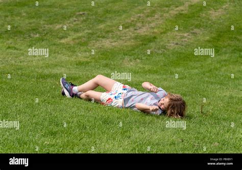 Girl rolling down hill hi-res stock photography and images - Alamy