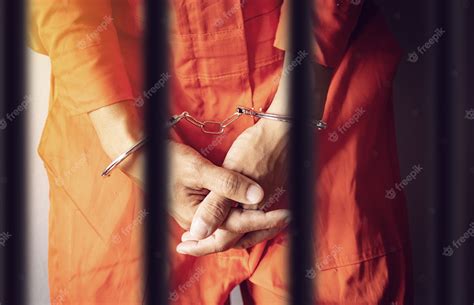 Premium Photo | Prisoner hands in handcuffs behind the prison