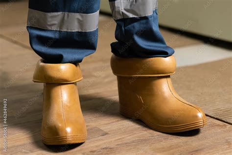 Electrician wears rubber boots for safety to avoid electric shock ...