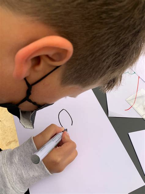 A 10-year old learner drawing an animal for inclusion in the training ...