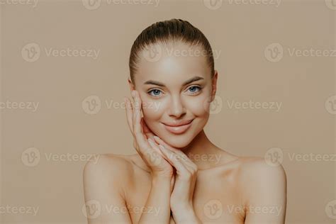 Natural beauty portrait. Fresh skin, gentle smile. Naked pose against