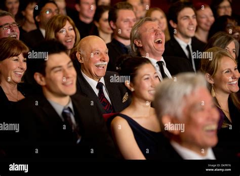 People smiling and laughing in theater audience Stock Photo - Alamy