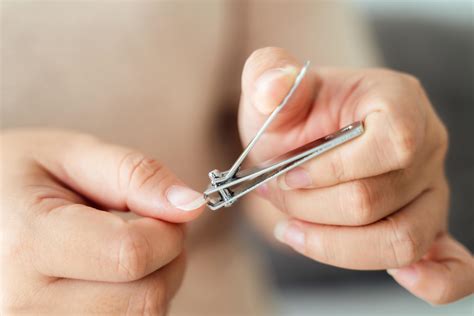 Woman cutting fingernails using nail clipper, Healthcare, Beauty