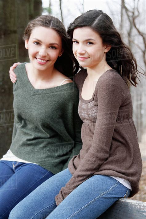 Two teenage girls (16-17) sitting together, portrait - Stock Photo ...