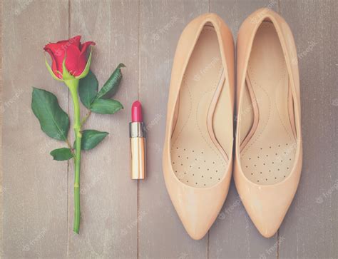 Premium Photo | Nude colored high heels still life with red rose bud